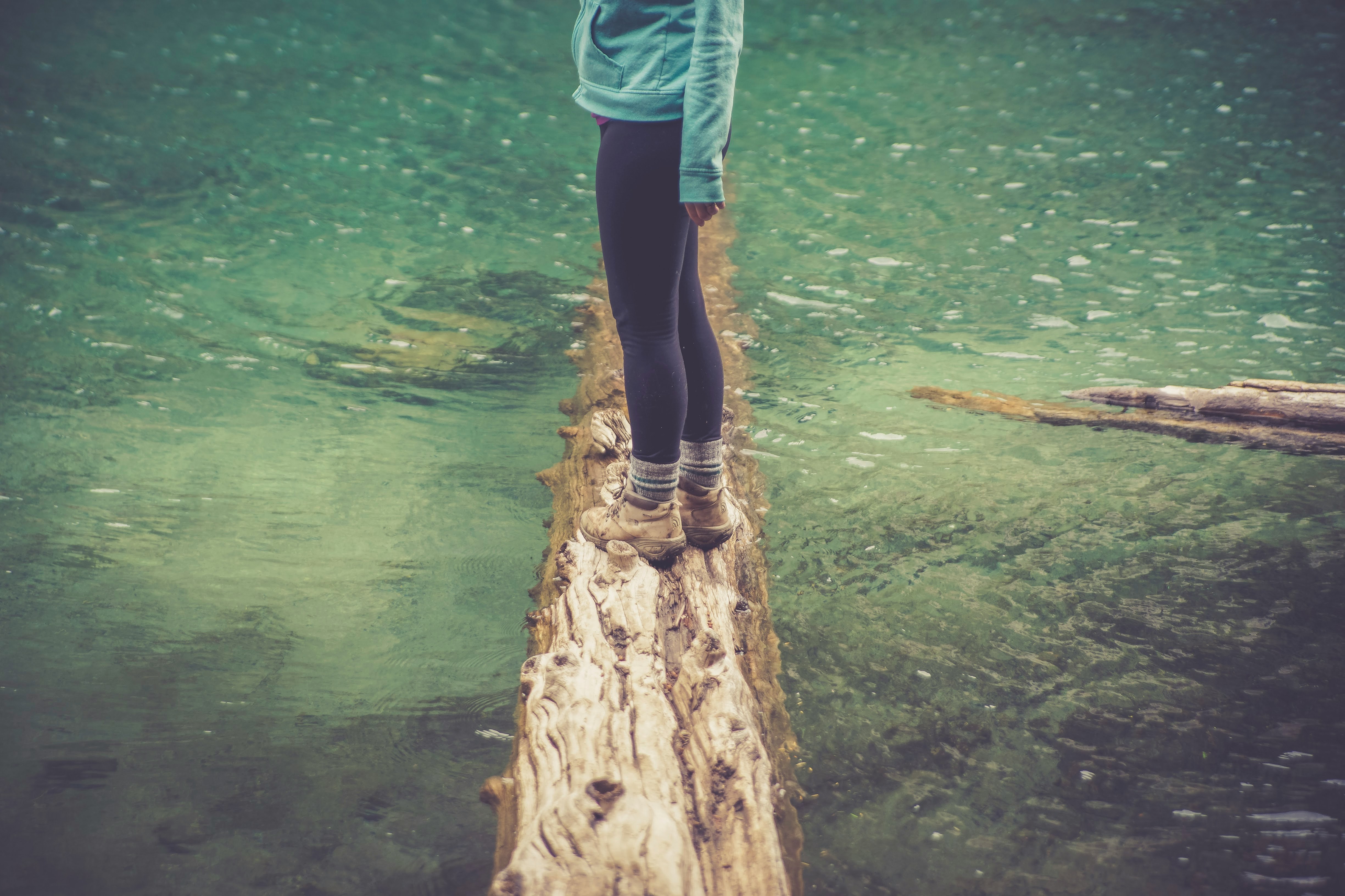 woman standing on log